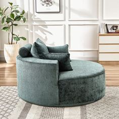 a living room with a round chair in the middle and a rug on the floor