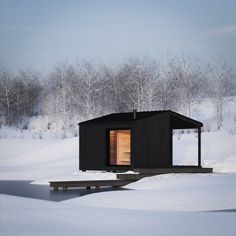 a small cabin in the middle of a snowy field