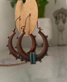 Costume earrings. Boho style in bronze look and turquoise detail. These are a lovely addition to any outfit. 45mm x 34mm Everything is zinc alloy. Comes in a drawstring bag. Bohemian Drop Earrings With Fish Hook, Adjustable Bohemian Patina Earrings, Bohemian Bronze Electroformed Hoop Earrings, Bronze Festival Earrings, Brown Copper Bohemian Hoop Earrings, Bohemian Electroformed Brass Hoop Earrings, Bohemian Festival Earrings With Patina, Bohemian Brown Electroformed Earrings, Bohemian Copper Hoop Earrings For Festivals