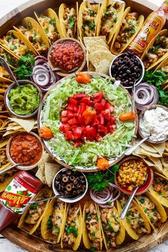 a platter filled with tacos, chips and salsa