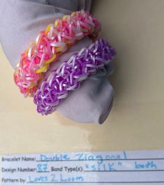 three different colored bracelets sitting on top of a table