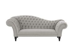 a grey couch with buttons on the back and arms, sitting in front of a white background