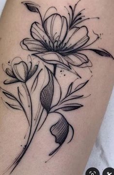 a black and white flower tattoo on the thigh