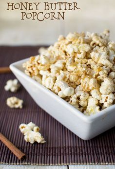 a white bowl filled with popcorn on top of a table