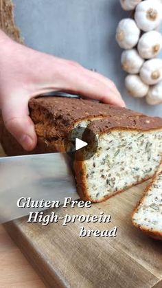 a person is cutting into a loaf of bread on a wooden board with the words gluten free high protein bread