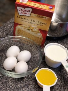 eggs, butter, and sugar are on the counter next to a package of lemon curd