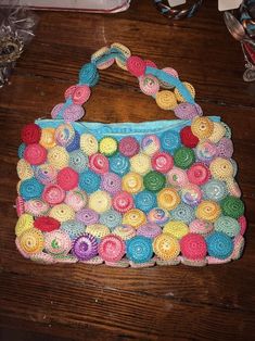 a crocheted purse sitting on top of a wooden table