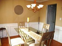 a dining room table with chairs and a chandelier