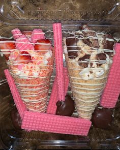 two ice cream cones with strawberries and chocolate covered strawberries in the bottom one