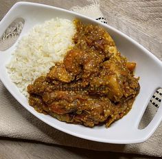 a white plate topped with meat and rice