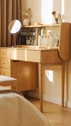 a bedroom with a wooden desk and mirror