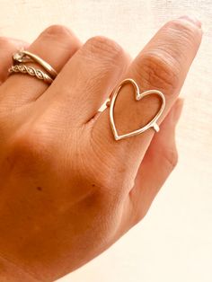 This Sterling Silver Hammered Heart Ring is perfect for any occasion - from casual everyday style to a romantic statement that feels as sweet as young love. PRODUCT DETAILS limited edition, Sizes: 7-10 This listing is for ONE (1) hammered open-heart ring. Material: Crafted from high-quality 925 Sterling Silver. ＊Please note that our rings are carefully handcrafted and hammered, which means that each finished product may have slight variations. Adjustable Rings For Everyday And Valentine's Day, Adjustable Heart Midi Rings For Everyday, Trendy Open Heart Ring For Valentine's Day, Simple Heart Rings For Valentine's Day, Valentine's Day Gift Midi Rings With Open Heart, Valentine's Day Gift Open Heart Midi Rings, Dainty Open Heart Rings For Everyday, Trendy Open Heart Ring For Anniversary, Handmade Open Ring For Valentine's Day