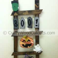 a wooden ladder with halloween decorations on it