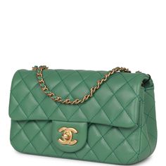 This Chanel Mini quilted rectangular pearl crush flap bag is of dark green lambskin leather with antique gold tone hardware and has a front flap with signature CC turnlock closure, rear half moon pocket, single interwoven dark green leather and antique gold tone chain link shoulder/crossbody strap. The interior is lined in dark green leather and features a zipper pocket with Chanel pull and an open pocket below. Collection: 23C Origin: Italy Condition: Pristine; new or never Accompanied by: Chanel box, Chanel dustbag, ribbon, felt and carebook Measurements: 8" width x 5" height x 2.5" depth; 20" strap drop Chanel Pearl Crush, Bags Wishlist, Chanel Pearl, Chanel Box, Chanel Pearls, Chanel Mini, Bag Dark, Chevron Quilt, Mini Quilt