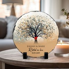 a personalized glass plate with a tree on it and a candle next to it