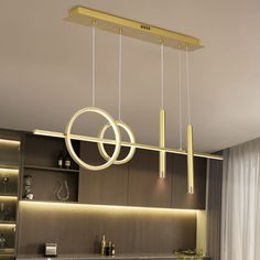 a modern light fixture hanging over a kitchen counter