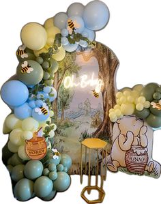 an arch with balloons and winnie the pooh decorations