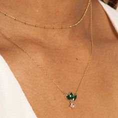 Elevate your elegance with an emerald marquise flower necklace featuring a princess-cut white sapphire dangle charm. Crafted from solid 10k gold, it showcases 0.81 carats of lab-created emeralds and 0.21 carats of lab-created white sapphires. Luxury Gold Emerald Necklace With Delicate Chain, Delicate Yellow Gold Emerald Necklace, Elegant Green Marquise Necklace, Formal Green Emerald-cut Emerald Necklace, 14k Yellow Gold Emerald-cut Emerald Necklace, Diamond Cleaner, Lab Created Emerald, Dangle Charms, Precious Gems