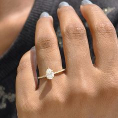 a woman's hand with a diamond ring on it