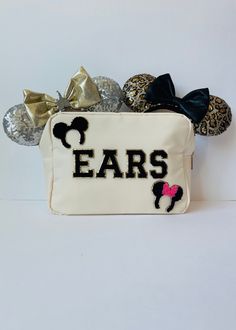 a white purse with ears on the front and minnie mouse ears on the back that says ears