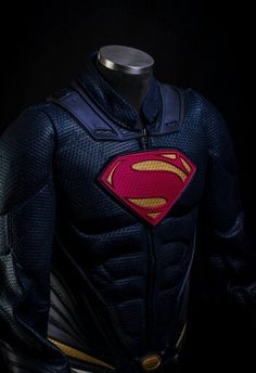 the superman costume is displayed on a mannequin's head and torso,