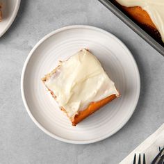 a piece of cake sitting on top of a white plate next to a fork and knife