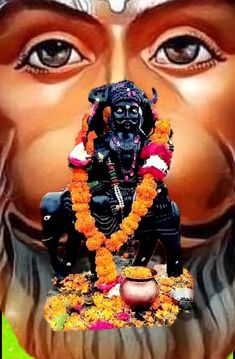 an image of the face of lord ganeshi with flowers around it and eyes open