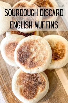 four english muffins on a wooden cutting board with the words sourdough discard