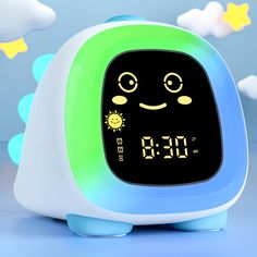 an alarm clock is sitting in the shape of a cartoon character with stars around it