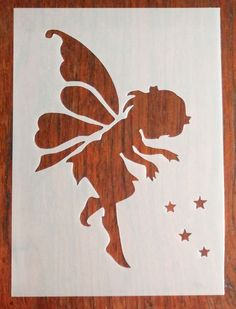 a paper cut out of a fairy with stars