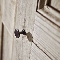 a close up of a door handle on a wooden door