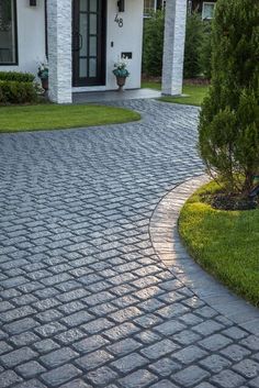 a brick driveway in front of a house