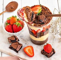 two desserts with strawberries and chocolate on the side