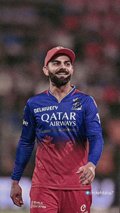 a man with a beard wearing a red and blue uniform is walking on the field