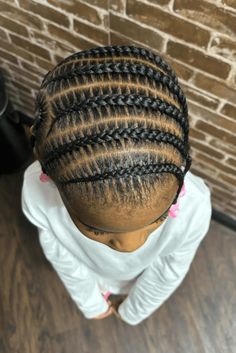 This classic cornrow hairstyle shows off really symmetrical braids that curve along the head in a neat way, making it look organized and clean. The braids start with small parts at the forehead and get bigger towards the top of the head, showing how skilled the person was who did it. This style is not only nice but also good for kids who play a - Click to see more of 20 Cute Cornrow Hairstyles for Children and follow us for more hairstyle ideas. // Photo Credit: Instagram @harlemhustlerz155 Cute Cornrow Hairstyles, Hairstyles For Children, Cornrow Hairstyle