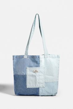 a blue and white tote bag sitting on top of a table