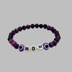 Celebrate the special bond between mother and child with our Mother's Day Bracelet! Made with 6mm or 8mm gemstone beads, this bracelet is a perfect way to show your love and appreciation. Give a meaningful gift that will be cherished for years to come. Purple Crystal Bracelet With 8mm Beads As A Gift, Purple Round Beaded Jewelry For Mother's Day, Purple Bracelets With 8mm Beads As Gift, Purple 8mm Beads Bracelets As Gift, Amethyst Stretch Bracelet With Round Beads For Gift, Hand-strung Round Beads Bracelets For Mother's Day, Hand-strung Bracelets For Mother's Day, Mother's Day Hand-strung Round Bead Bracelets, Luxury Hand-strung Beaded Bracelets For Mother's Day