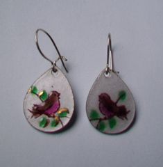 This is a cute pair of Handpainted enamel earrings.Teardrop shape with a Brown Robin Bird on branch design.3/4" longSterling kidney wireEach color is handpainted on the metal, then fired in a kiln. Then the next color is put on.  These have been fired 5-6 times.Each one is done by hand, so no two pieces are exactly alike.  Tweet Yourself or someone else to a special pair of earrings.Thanks for looking Teardrop Enamel Earrings For Gifts, Whimsical Hand Painted Silver Earrings, Soldered Enamel Drop Earrings, Robin Red Breast, Pink Dinosaur, Robin Bird, Earrings Teardrop, Branch Design, Bird On Branch