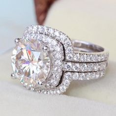 a close up of a diamond ring on top of a white cloth with the words port city jewelers