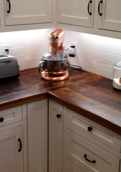 a kitchen counter top with a mixer and toaster on it