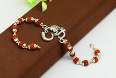 925 sterling silver handmade custom design  'Aum' Bracelet Or Rakhi with rudraksha chain, this is special design Rudraksha rakhi for Rakshabandhan Festival in India, best wishes gift for your brother and sister's , Metal-925 sterling silver.Item type-Rakhi Bracelet.Length-8.0 inches.(length will be customized if buyer request)Weight-7.970 grams.Aum size-2.6 cm diameter.Rudraksha size-6 mm approx.Stamped-925.Make excellent gifting and collectible pieces(gift for birthday, wedding, anniversary, mo Adjustable Sterling Silver Bracelets For Diwali, Temple Jewelry Bracelets With Round Beads For Gifts, Traditional Sterling Silver Bracelet With Silver Beads As Gift, Traditional Gift Sterling Silver Bracelet With Silver Beads, Rudraksha Rakhi, Silver Rakhi, Rudraksha Bracelet, Rakhi For Brother, Rudraksha Beads