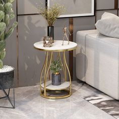 a living room with a couch, table and potted plant on the floor in front of it