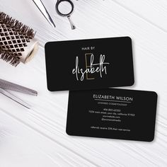 two black business cards with the words mary elizabeth on them next to scissors and combs