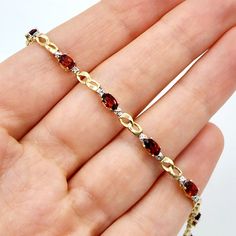 10K Yellow Gold Bracelet Ten Genuine Garnet 2.3cts Size of each stone: 5x3mm With 2 Diamonds 0.02cts Weight: 4 gm Length: 7 inches Made in Canada Garnet is the birthstone for January and known as the stone of regeneration and passion. Comes in a Beautiful Gift Box / Perfect for Gifting This item is available in different gemstone selections. Please feel free to message me if you need any further information or if you have specific preferences regarding the gemstone for your order. Garnet And Gold, Garnet Bracelet, Garnet Jewelry, Wedding Jewelry Bracelets, January Birthstone, White Gold Diamond Rings, Yellow Gold Bracelet, Memorial Jewelry, Body Piercing Jewelry