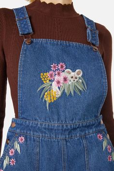 Denim embroidered overall- featuring the cutest embroidered Greater Glider hiding amongst lush Australian flora- a easy relaxed overall style to layer over any top- bib & brace bodice- wide leg cut- handy side pockets- button opening at side and adjustable shoulder straps- made of a cotton denim- available in blue mid denim Product Code: PGFX415 Patches On Overalls, Overalls Embroidery Ideas, Dangerfield Clothing, Winter Overalls Outfit, Easy Cute Outfits, Greater Glider, Overall Embroidery, Overall Dress Outfit, Flower Outfits