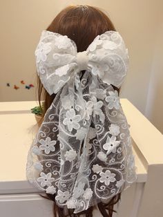 Adorable flower embroidery hair bow. So fun for a unique bridal look. Great for reception or bachelorette party wear, too! The entire bow measures about 7.8" across and the ties hang about 16" long. Use alligator clipper to connect. All hair bows are raw cut edge, the sides and bottom of the bow will be left raw."the embroidery on a Cut Edge veil may fray with wear and care" Lace colors may appear different in person based on monitor setting, environmental lighting, and photographer editing style. If you need the swatch before you order a veil please contact me to order a swatch. White Bow For Spring Party, White Hair Accessories With Decorative Bow For Summer, White Decorative Bow Hair Accessories For Summer, White Ribbon Bow For Spring, Detachable Bow For Spring Wedding, Spring Wedding Bow, White Flower-shaped Hair Accessories With Matching Headband, White Floral Hair Accessories With Matching Headband, White Bow Headband Hair Accessory