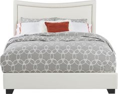 a white bed with grey and red pillows on it's headboard, in front of a white background