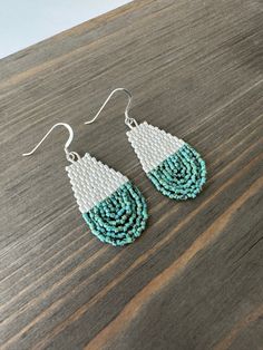 "Handmade with the highest quality Japanese Miyuki Delica 11/0 glass beads in ivory and turquoise picasso beads.  Over 850 seed beads are handwoven in double brick stitch into this simple statement pair of earrings. Sterling Silver ear wires.  Choose between two sizes. The larger pair is approximately 2.75\" long and 1\" wide and the smaller pair is approximately 2\" long and .75\" wide. Each piece is designed by me and handwoven with care and attention to detail which can take several hours to complete.  CUSTOM OPTIONS: If you prefer a different ear wire, please message me for what other options may be available.  SHIPPING: Tasha Jane Designs uses USPS Ground Advantage.  If needed in a quicker timeline, please message me. Shipping charges will be adjusted to reflect a different timeline. Turquoise Earrings With Silver Round Beads, Turquoise Teardrop Earrings With Faceted Beads, Turquoise Beaded Earrings With Silver Beads As Gift, Turquoise Teardrop Earrings With Tiny Beads, Silver Teardrop Beaded Earrings, Gift Teardrop Beaded Earrings With Silver Beads, Teardrop Silver Beaded Earrings As Gift, Gift Teardrop Silver Beaded Earrings, Double Brick Stitch