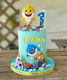 a birthday cake with an image of a shark and fish on it