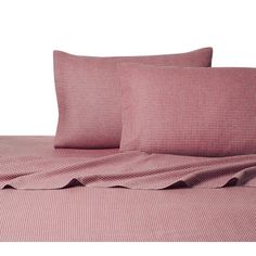 a bed with pink sheets and pillows on top of it, in front of a white background